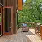 living-stone-–-north-haven-rustic-–-creston-–-black-mountain-nc-–-custom-home-–-deck-bifold-doors-wicker-chair-–-24