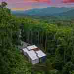 living-stone-–-wandering-oaks-modern-–-asheville-nc-–-custom-home-–-aerial-twilight-forest-mountain-view-drone-–-03
