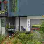 living-stone-–-wandering-oaks-modern-–-asheville-nc-–-custom-home-–-exterior-entry-balcony-drone-–-01
