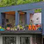 living-stone-–-wandering-oaks-modern-–-asheville-nc-–-custom-home-–-exterior-upper-balcony-colorful-furniture-drone-–-02