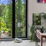 living-stone-–-wandering-oaks-modern-–-asheville-nc-–-custom-home-–-living-area-open-bookshelf-floor-to-ceiling-windows-–-05