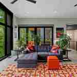 living-stone-–-wandering-oaks-modern-–-asheville-nc-–-custom-home-–-living-room-sectional-sofa-colorful-rug-forest-view-–-10