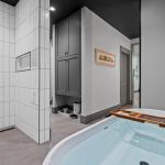 living-stone-–-wandering-oaks-modern-–-asheville-nc-–-custom-home-–-primary-bath-soaking-tub-rain-shower-white-tile-–-15