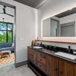 living-stone-–-wandering-oaks-modern-–-asheville-nc-–-custom-home-–-primary-bath-walnut-double-vanity-backlit-mirror-–-14