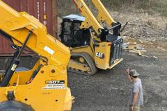 living-stone-team-loading-steel-beam-skid-steer-01