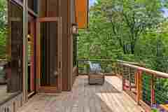 living-stone-–-north-haven-rustic-–-creston-–-black-mountain-nc-–-custom-home-–-deck-bifold-doors-wicker-chair-–-24