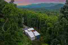living-stone-–-wandering-oaks-modern-–-asheville-nc-–-custom-home-–-aerial-twilight-forest-mountain-view-drone-–-03