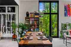 living-stone-–-wandering-oaks-modern-–-asheville-nc-–-custom-home-–-dining-room-wood-table-wine-wall-forest-windows-–-08