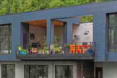 living-stone-–-wandering-oaks-modern-–-asheville-nc-–-custom-home-–-exterior-upper-balcony-colorful-furniture-drone-–-02