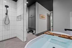 living-stone-–-wandering-oaks-modern-–-asheville-nc-–-custom-home-–-primary-bath-soaking-tub-rain-shower-white-tile-–-15