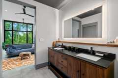 living-stone-–-wandering-oaks-modern-–-asheville-nc-–-custom-home-–-primary-bath-walnut-double-vanity-backlit-mirror-–-14