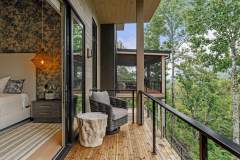living-stone-–-waterfall-overlook-–-hendersonville-nc-–-custom-home-–-balcony-lounge-chair-forest-view-–-11