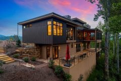 living-stone-–-waterfall-overlook-–-hendersonville-nc-–-custom-home-–-exterior-twilight-stone-retaining-wall-–-01