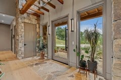 living-stone-–-waterfall-overlook-–-hendersonville-nc-–-custom-home-–-foyer-stone-column-potted-palms-–-28